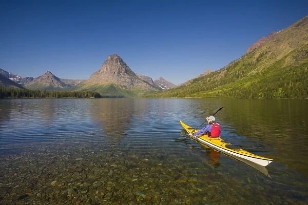 USA, Montana, Glacier National Park, Male sea kayaker on Two Medicine Lake. (MR)