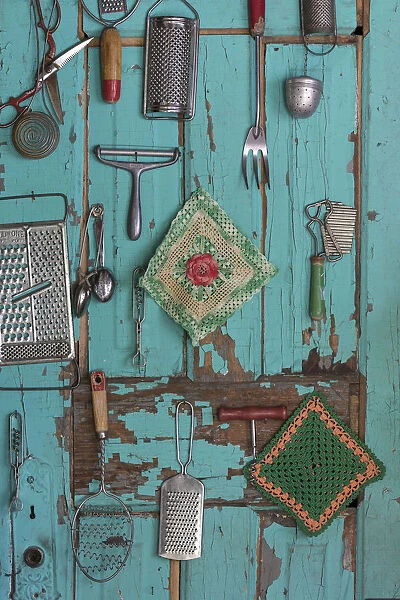 USA, Montana, Missoula. Old fashioned kitchen implements displayed on weathered door