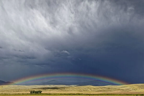 USA, Montana. Rainbow over stormy landscape. Credit as: Dennis Flaherty  /  Jaynes Gallery