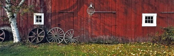 USA, New Hampshire, Franconia Notch. Autumn color enhances the deep red siding of