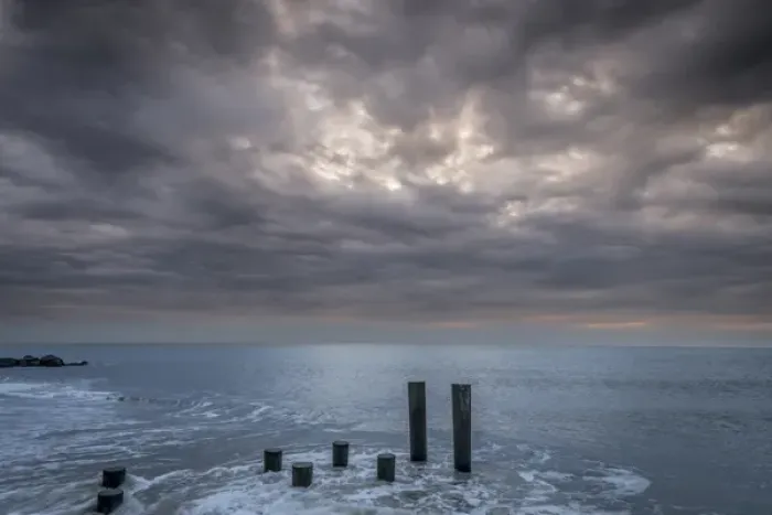 Framed Print : USA, New Jersey, Cape May National Seashore. Beach pilings on stormy sunrise. Credit as