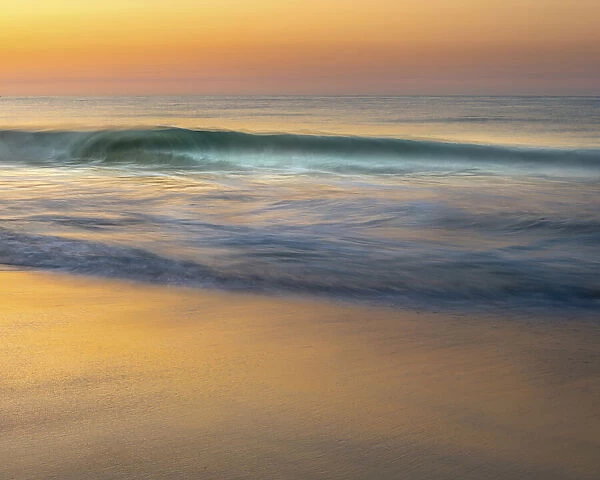 USA, New Jersey, Cape May National Seashore. Wave on beach at sunrise