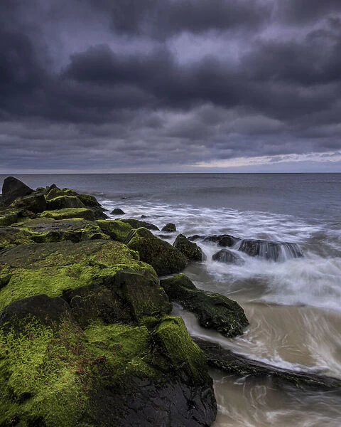 USA, New Jersey, Cape May National Seashore. Storm waves crash on rocks