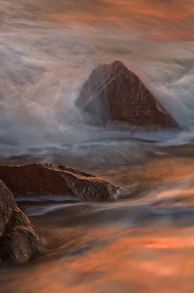 USA, New Jersey, Cape May. Wave crashes on shoreline rocks