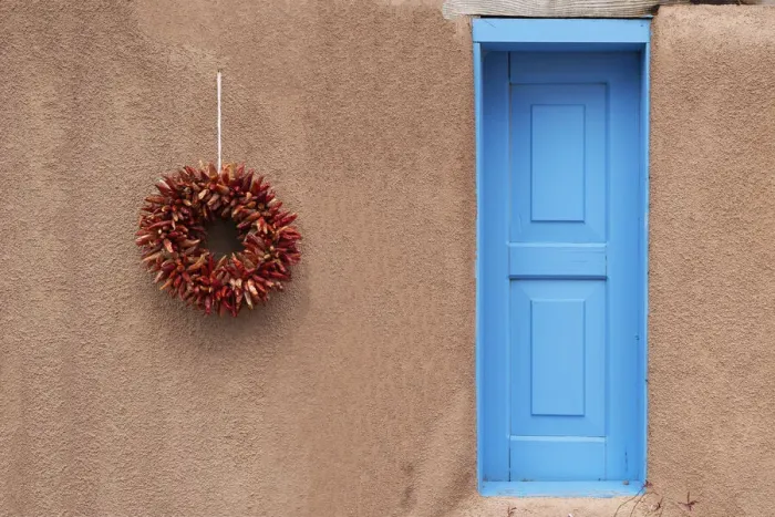 Framed Print : USA, New Mexico, Taos. Mission Ranchos de Taos, Adobe wall of residence with blue door