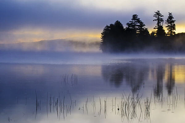 USA, New York, Adirondack Mountains. Autumn sunrise on Raquette Lake. Credit as