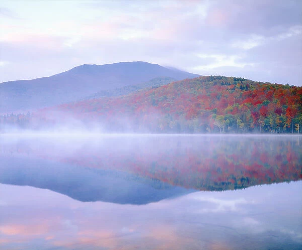 USA; New York; Algonquin Peak and autumn colors relecting in a misty Heart Lake in