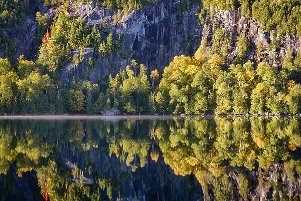 USA, New York State. Autumn reflections in Chapel Pond, Adirondack Mountains