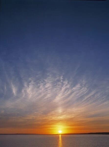 USA, North Dakota, Lake Sakakawea. Wispy sunset clouds settle over the dusky waters