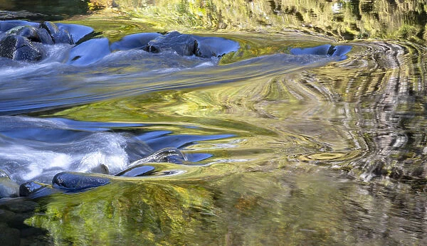 USA, Oregon. Abstract of autumn colors reflected in Wilson River rapids. Credit as