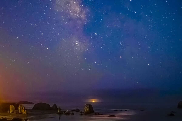 USA, Oregon, Bandon Beach. Lunar eclipse and Milky Way at night