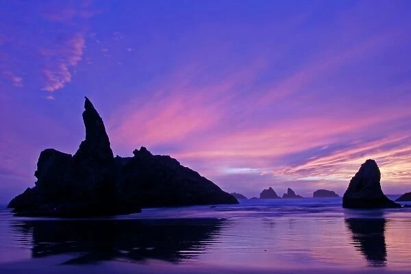 USA, Oregon, Bandon Beach. Silhouette of sea stack formations at sunset. Credit as