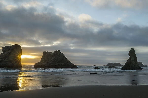 USA, Oregon, Bandon Beach. Wizards Hat and other formations at sunset