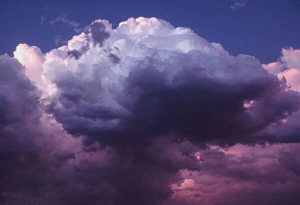 USA, Oregon, Bend. Roiling clouds take on the dramatic tones of lavender, pink and gray