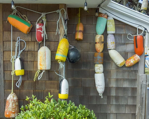 USA, Oregon, Cannon Beach. Buoys hang on side of house