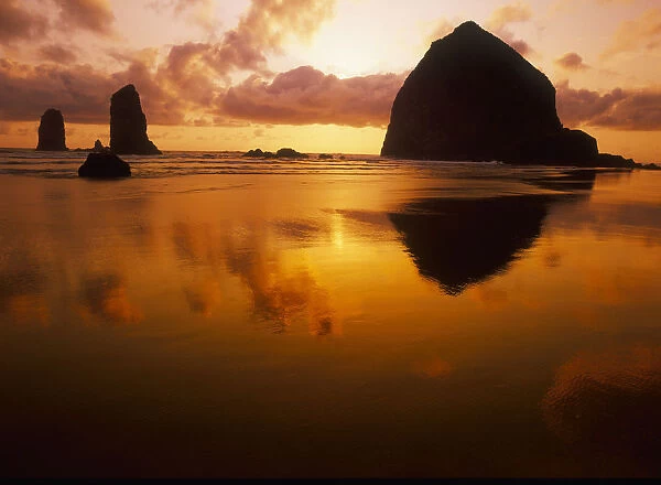 USA, Oregon, Cannon Beach Haystack Rock silhouetted at sunset