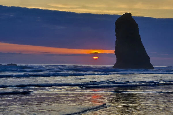 USA, Oregon, Cannon Beach. Sunset on lone sea stack