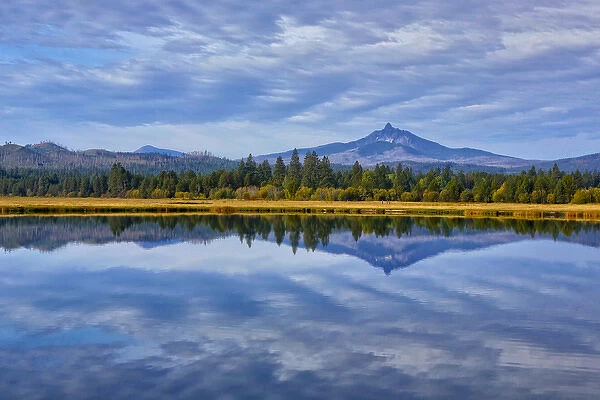 USA, Oregon. Clouds reflect in small lake at Black Butte Ranch