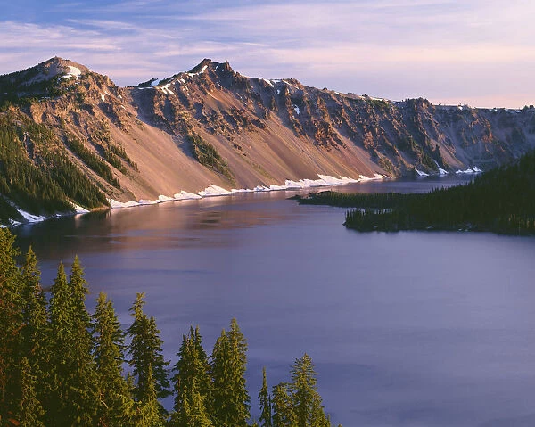 USA, Oregon. Crater Lake National Park, sunrise on west rim of Crater Lake with The Watchman