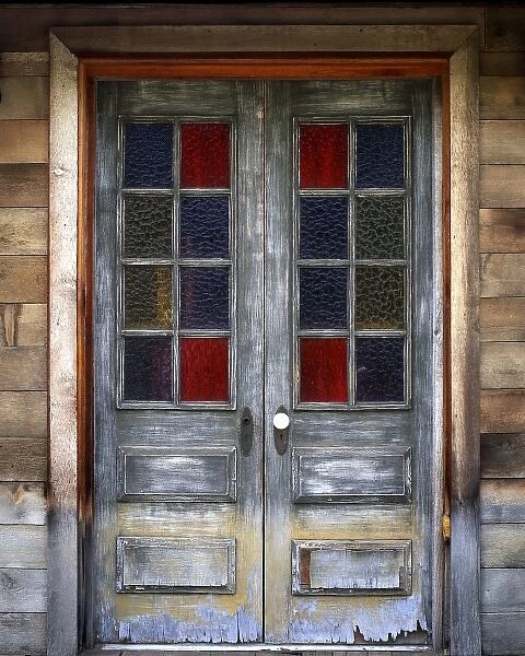 USA, Oregon, Deschutes County. Old weathered doors with stained-glass windows