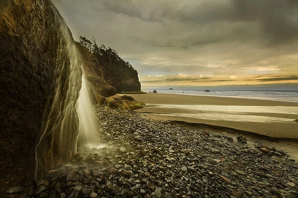 USA, Oregon. Hug Point Falls flows onto beach