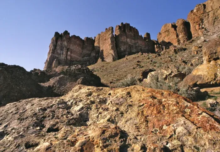Framed Print : USA, Oregon, John Day Fossil Beds NM. The Clarno Palisades tower above the rocks