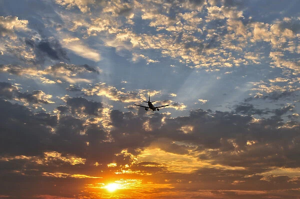 USA, Oregon, Portland. Airplane landing at sunset