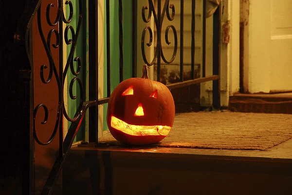 USA, Oregon, Portland. Lighted jack-o-lantern on front porch awaiting trick or treaters