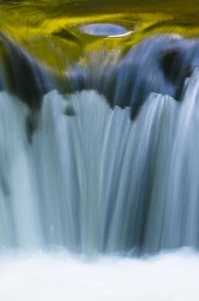 USA, Oregon. Reflections in waterfall on Sweet Creek