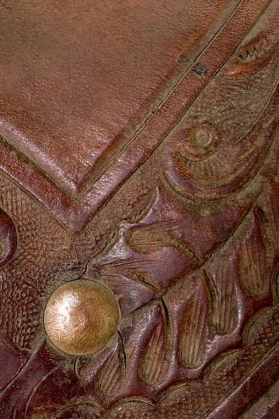 USA, Oregon, Seneca, Ponderosa Ranch. Details of tooling on leather saddle