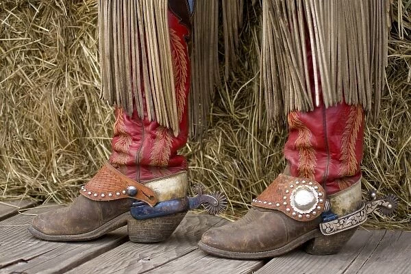 USA, Oregon, Seneca, Ponderosa Ranch. Cowgirls boots with leather fringes hanging from chaps