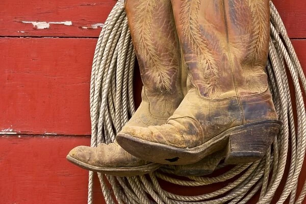 USA, Oregon, Seneca, Ponderosa Ranch. Close-up of cowboy boots and rope hanging
