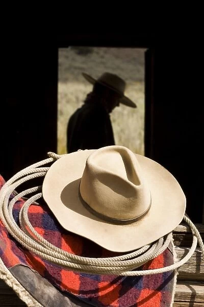 USA, Oregon, Seneca, Ponderosa Ranch. Cowboy hat, lasso, and horse blanket sitting on window ledge