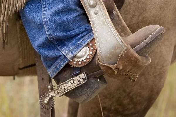 USA, Oregon, Seneca, Ponderosa Ranch. Detail of cowboy boot and spur in a stirrup