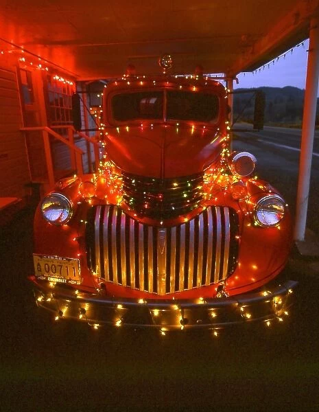 USA, Oregon. Vintage fire truck decorated with lights at Christmas. Credit as: Steve