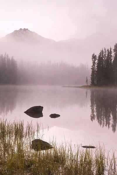 USA, Oregon, Willamette National Forest. Foggy sunrise on Scott Lake and Three Sisters mountains