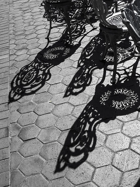 USA, Pennsylvania. Wrought iron chairs and shadows on a patio on a sunny day