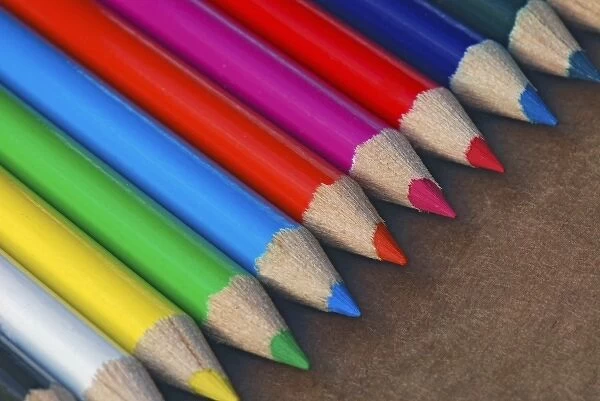 USA, Row of multicolored pencils on paper