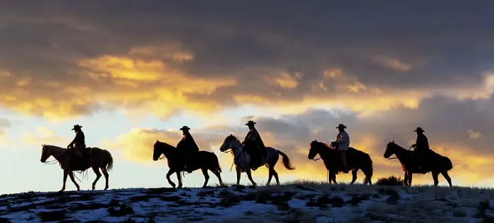 Framed Print : USA, Shell, Wyoming. Hideout Ranch cowboys and cowgirls silhouetted against sunset riding on ridgeline. (PR, MR)