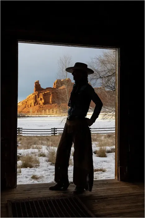 Framed Print : USA, Shell, Wyoming. Hideout Ranch with cowgirl silhouetted in doorway of log cabin. (PR, MR) Framed Print : USA, Shell, Wyoming. Hideout Ranch with cowgirl silhouetted in doorway of log cabin. (PR, MR)