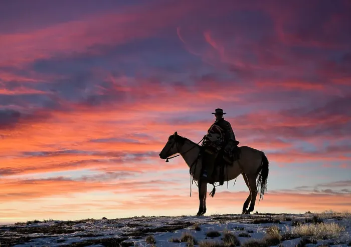 Framed Print : USA, Shell, Wyoming. Hideout Ranch cowgirl silhouetted on horseback at sunset. (PR, MR)