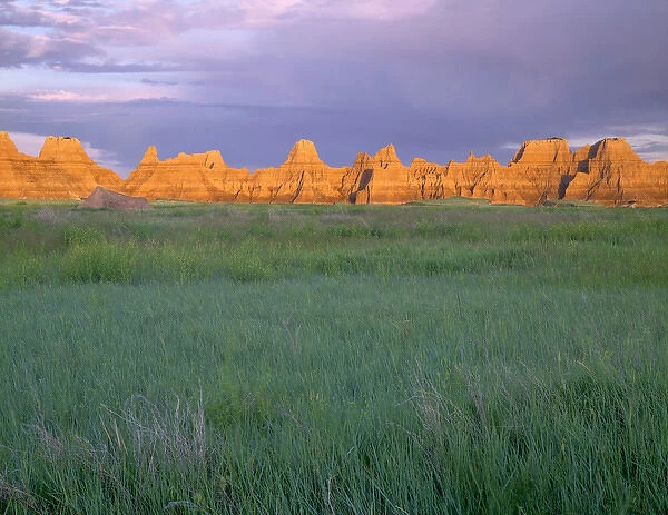 USA, South Dakota, Badlands National Park, Sunrise light on eroded pinnacles above