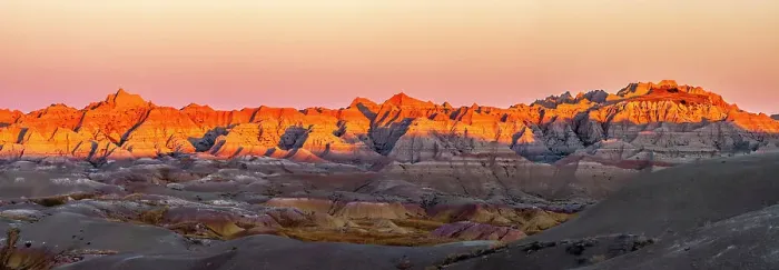 Framed Print : USA, South Dakota, Badlands National Park. Panoramic of sunrise on arid park formations