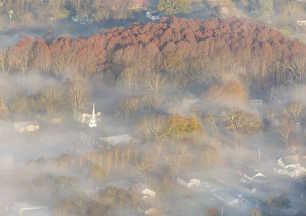 USA, Tennessee. Church steeple rises above fog