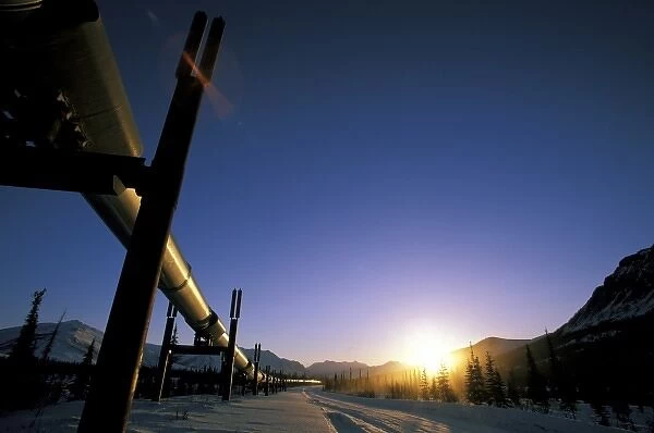 USA, USA, Alaska, Brooks Range. Winter sun sets over the Trans-Alaska Oil Pipeline