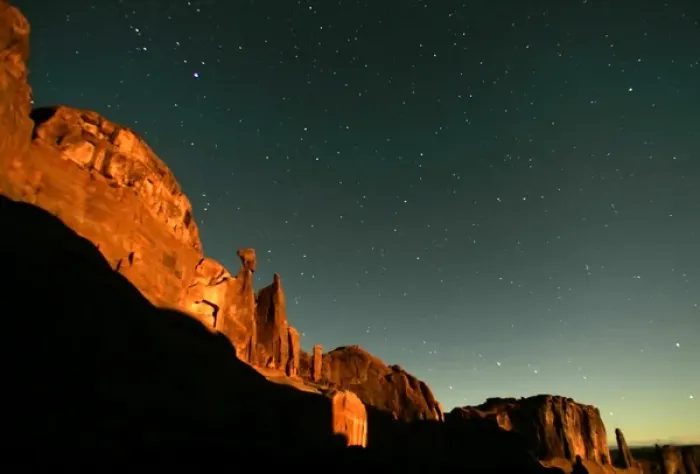 Framed Print : USA, Utah, Arches National Park. Moonrise highlights Park Avenue, with star points