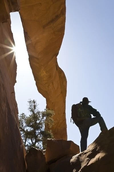 USA, Utah, Arches National Park. Lone hiker stands under Wall Arch one month before it collapsed
