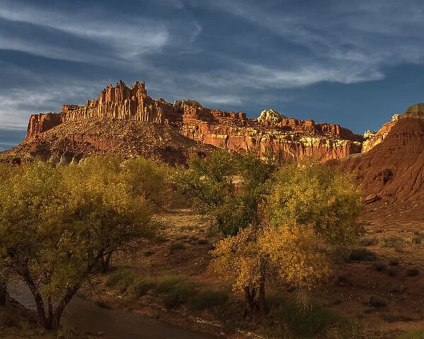 USA, Utah, Capital Reef National Park. Sunrise on mountain formations and trees