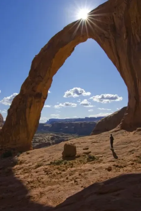 Framed Print : USA, Utah. A female hiker dwarfed by the Corona Arch near Moab. (MR) Framed Print : USA, Utah. A female hiker dwarfed by the Corona Arch near Moab. (MR)