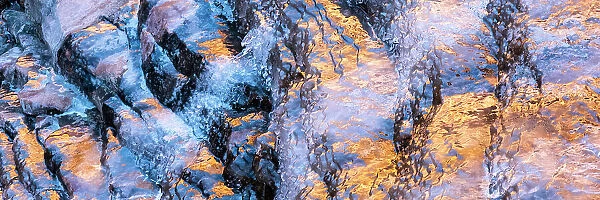 USA, Utah. Ice formations with canyon wall reflections Arches National Park